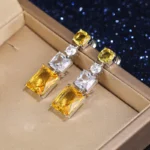 American Diamond Studded Yellow Geometrical Crushed Ice Cut Drop Earrings